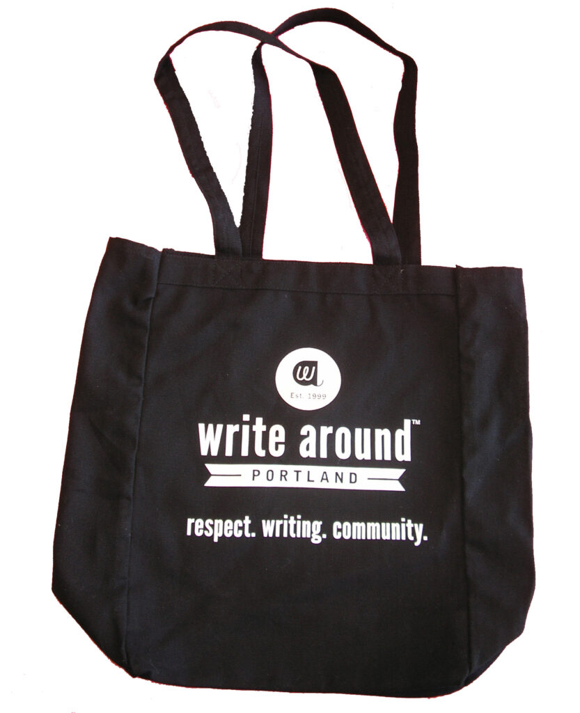 The Write Around Portland tote bag is black with a white logo, and the words respect. writing. community. in white.