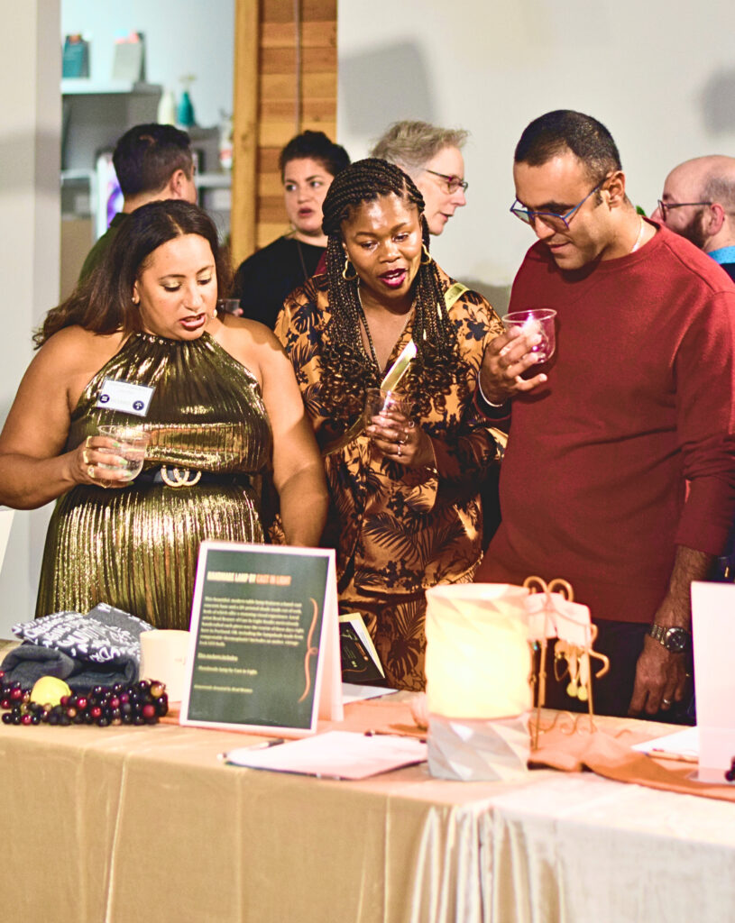 Three people talk about an item they see at an auction.